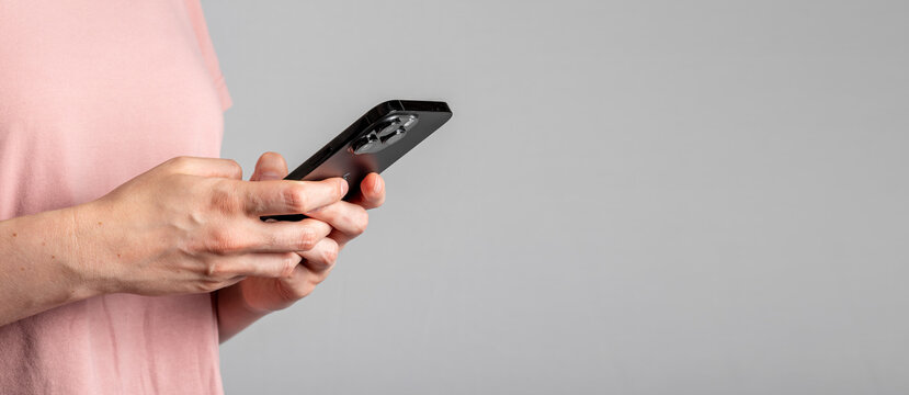 Berlin, Germany June 15 2023 Hand holding mobile phone, texting message on smartphone closeup. Banner background