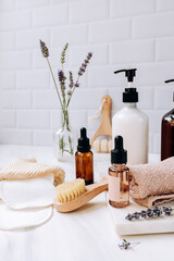 Fototapeta na wymiar Bottles lavender shampoo or shower gel Lotion, essential oil, cream, massage brushes, Body and face care beauty bath set 