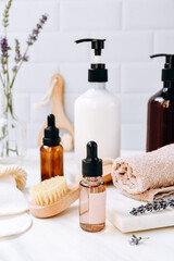 Fototapeta na wymiar Bottles lavender shampoo or shower gel Lotion, essential oil, cream, massage brushes, Body and face care beauty bath set 