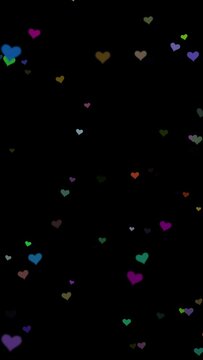 Colourful heart shapes slow vertical flying on black background.