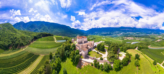 Medieval beautiful castles of northern Italy  - splendid Thun castel amongst the apple trees of Val di Non. Trentino region, Trento province.  Aerial drone panoramic view - 624165614
