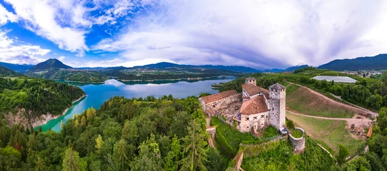 Poster  most famous and beautiful medieval castles of northern Italy. scenic Cles  castel- in Trentino , province of Trento. surrouded by fields of apple trees near the lake Santa Giustina © Freesurf