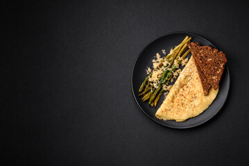 Delicious nutritious breakfast consisting of asparagus, scrambled eggs, salt, spices and herbs