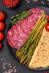 Delicious nutritious breakfast consisting of asparagus, scrambled eggs, salt, spices and herbs