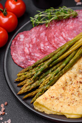 Delicious nutritious breakfast consisting of asparagus, scrambled eggs, salt, spices and herbs