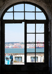 Looking out the window of an abandoned building in Lisbon, Portugal, during a sunny day