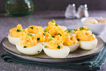 Eggs filled with a mixture of yolk, cheese, garlic and mayonnaise on a plate