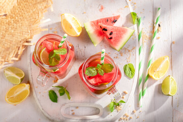 Tasty lemonade with crushed ice and fruits in a jar.