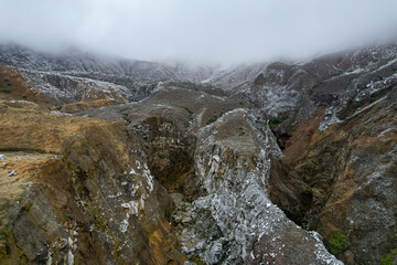 Beautiful nature view of the the Poas Volcano Canon, mountains and trial hick to the tourquoise waters with explorers