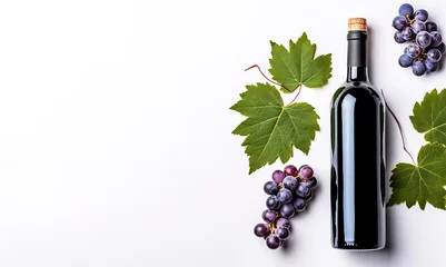  Bottle of red wine with ripe grapes and  vine leaves on white background. Copy space, top view. © Viks_jin