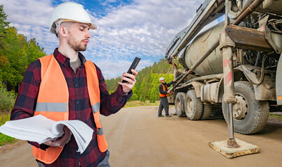 Man road worker. Guy near concrete mixer. Road construction process. Preparation for laying...
