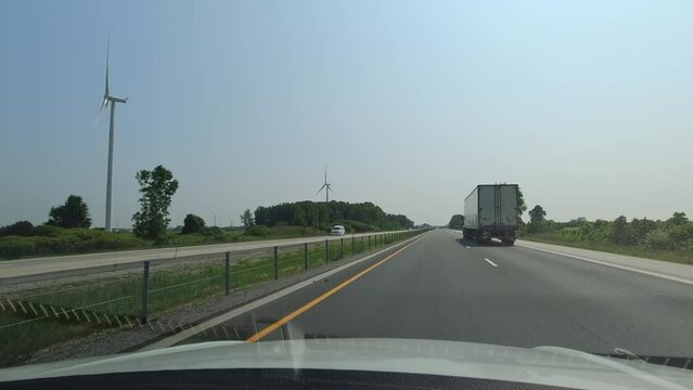 Point of view, car front view driving view,  POV on highway during travel. Roads of Canada. Car driving on road with traffic. Countryside adventure travelling on the 401 Highway, Ontario, Canada