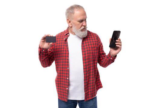 handsome 60s middle-aged mature man in a stylish image advertises a bank card and a smartphone
