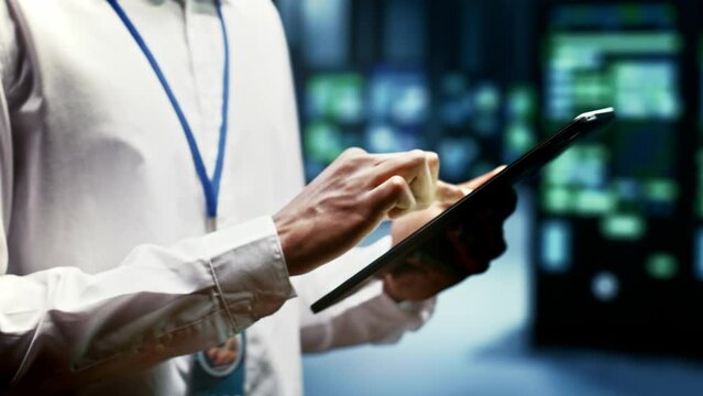 Close up of skillful engineer doing inspection in blockchain technology application specific integrated circuit data center. Experienced technician working in mining facility