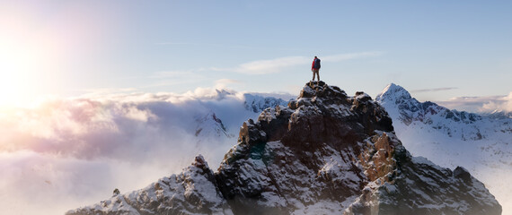 Adventurous Man Standing on top of Mountain Cliff. Dramatic Extreme Adventure Composite