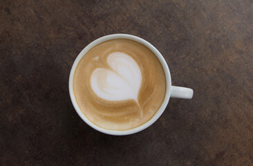 Cup of cappuccino coffee decorated with heart