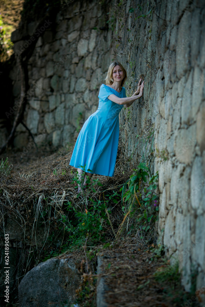 Sticker A woman in a blue dress makes her way through ancient ruins.