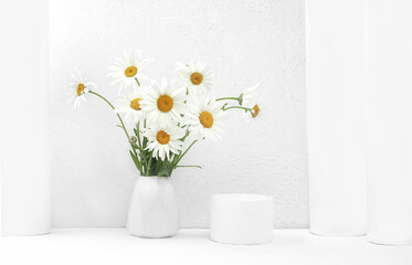 Beautiful chamomile flowers in a vase on a light background with place for text, summer banner for advertising, minimal holiday concept with flowers, greeting card for wedding, birthday, mother's day