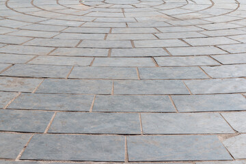 Photograph of smooth stone tiled floor in circular pattern.