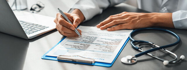 Doctor carefully review detailed medical report with laptop and diagnosing illness for effective...