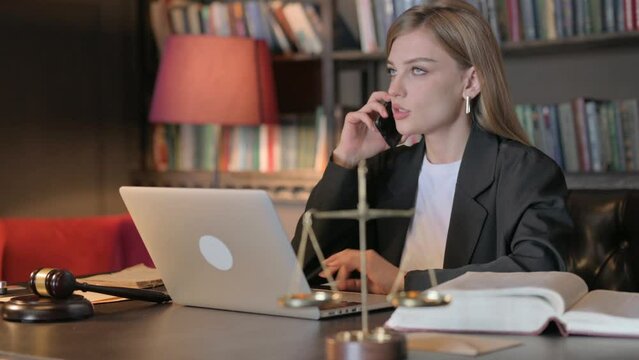 Female Lawyer Talking on Phone in Office