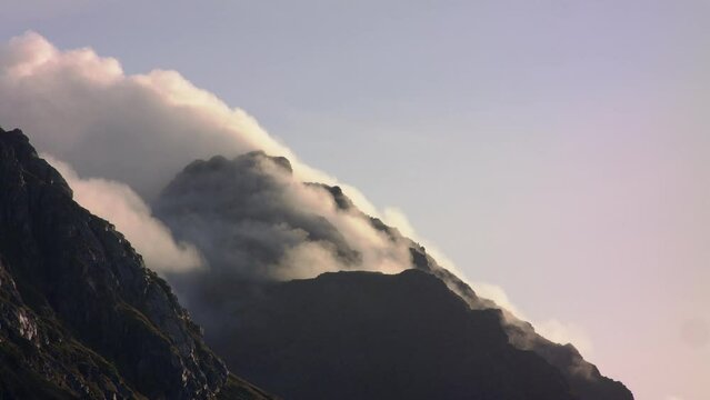 Fog rising from mountain peak in Haukland beach, Lofoten