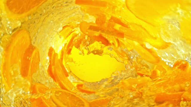 Super Slow Motion Shot of Orange Slices and Water Rotating in Wave at 1000fps.