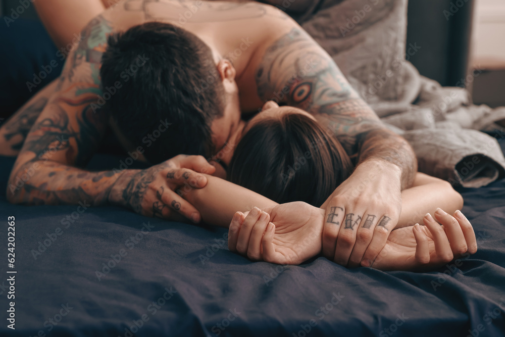 Wall mural passionate couple having sex on bed, focus on hands