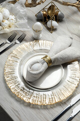 Easter table setting with bunny ears made of egg and napkin, above view