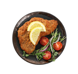 Plate of delicious schnitzels with lemon, tomatoes, onion and microgreens isolated on white, top view