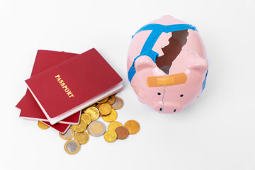 Broken piggy bank, money iron coins, red passport. Concept of moving abroad, legalization, residence permit, buying fake documents. Costs for relocation, emigration, sanction, confiscation of finances - obrazy, fototapety, plakaty
