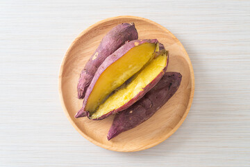 Grilled or baked Japanese sweet potatoes on wood plate