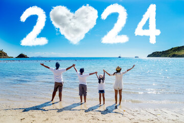 Cheerful family standing together looking at clouds shaped numbers 2024 new year numbers and heart