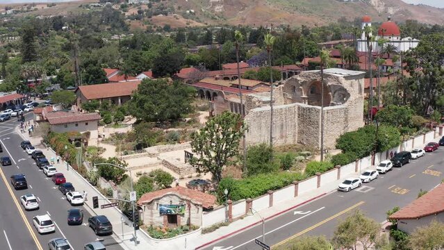 Low panning aerial shot of the ruins of the Great Stone Church at Mission San Juan Capistrano in California. 4K