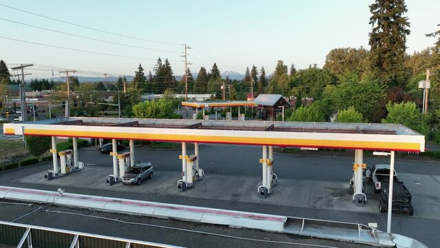 Aerial view of a petrol station with cars filling up their tanks.