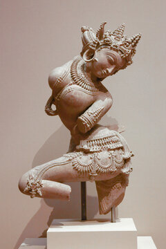 Manhattan, NY - November 4, 2022: 11th century Indian Celestial Dancer Apsara sandstone statue on display in the Metropolitan Museum of Art linked to Subhash Kapoor illegal black market smuggling 