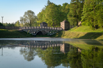 Fototapeta premium View of the White Lake in Gatchina Park and the stone bridge at the Konetable Square on a sunny summer day, Gatchina, Leningrad region, Russia