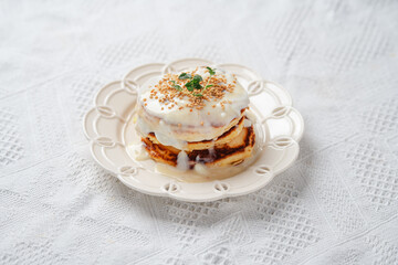 Pancakes topped with whipped cream and bee pollen