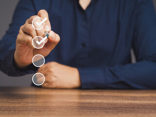 Business people tick correct sign white marks in checkboxes while sitting at the table.