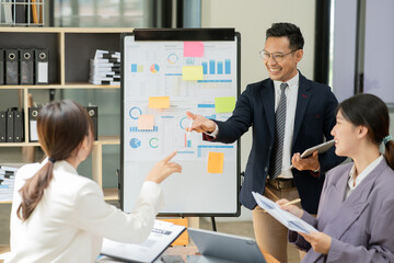 Group of asian business people working, discussing new projects together, having fun at the office.