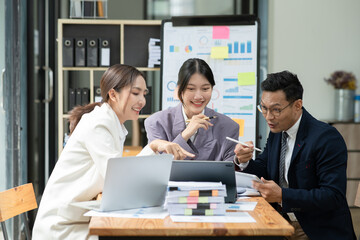 Group of asian business people working, discussing new projects together, having fun at the office.