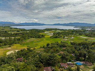 Fototapeta na wymiar Lake Toba and farmland in the highlands view from above. Sumatra, Indonesia.
