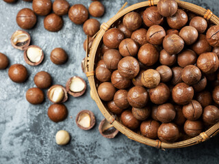 Roasted macadamia nuts on a dark background