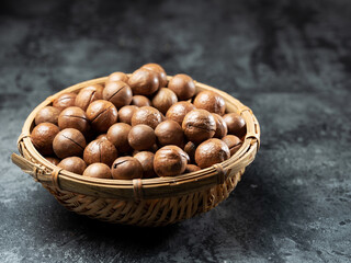 Roasted macadamia nuts on a dark background