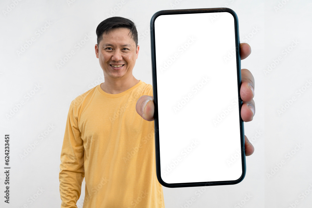 Poster satisfied confident smiling man showing mobile phone blank white screen mockup to camera standing is