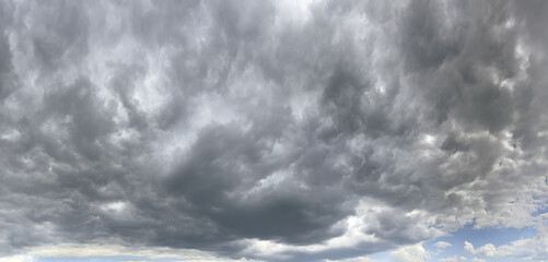 Obraz premium dark overcast sky with stormy clouds before rain. panoramic view. natural sky background.