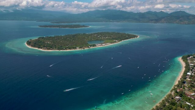 High aerial view from the three Gili Islands in Indonesia.
Gili Trawangan, Gili Meno, Gili Air and Lambok Island at the background.