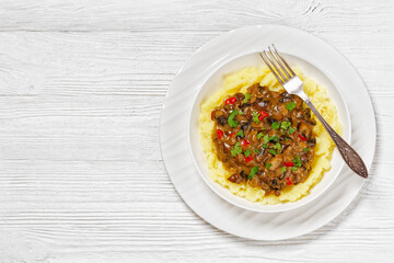 potato mash topped with mushroom gravy in bowl