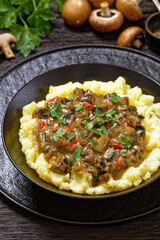 potato mash topped with mushroom gravy in bowl