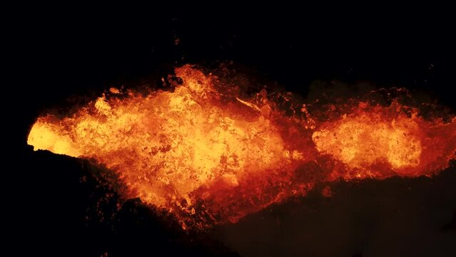 Close-up shot of magma splashing out of crater of Litli Hrutur volcano in Iceland